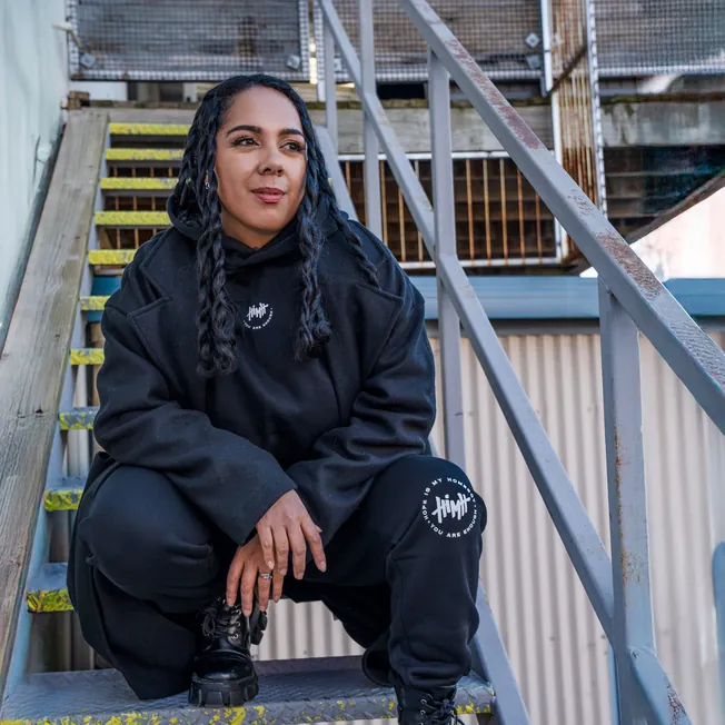 Hope Is My Homeboy hoodie and track pants, worn on an outdoor staircase
